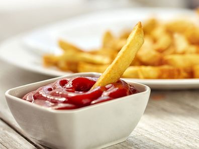 Chip dipped in tomato sauce