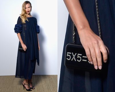 <p>Natasha Poly's clutch plus a deep blue gown is the only equation you need to know.</p>