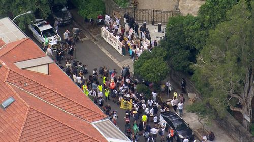 A large group of students gather outside Kirribilli House for the climate protest.