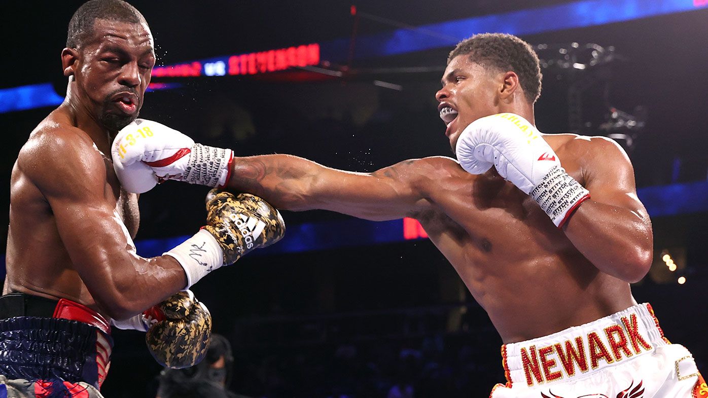 Jamel Herring (L) and Shakur Stevenson (R) exchange punches during their fight for the WBO world junior lightweight championship fight 