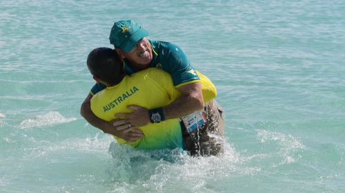 Dane Bird-Smith hugs his father and coach David Smith. (AAP)