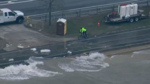 A brave cyclist is seen dodging chunks of ice. (ABC-7 Chicago)