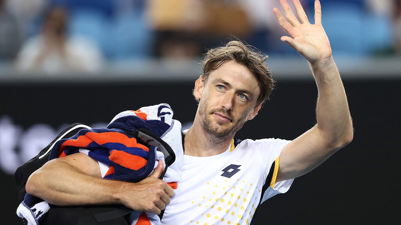 John Millman waves to the crowd during the 2022 Australian Open
