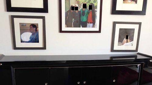 This undated, redacted photo released by Democrats on the House Oversight Committee shows a framed photo of Bill Gates. (House Oversight Committee via AP)