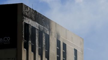 Smoke escapes out of windows as a drone surveys the scene after a fire at Loafers Lodge on May 16, 2023 in Wellington, New Zealand. 