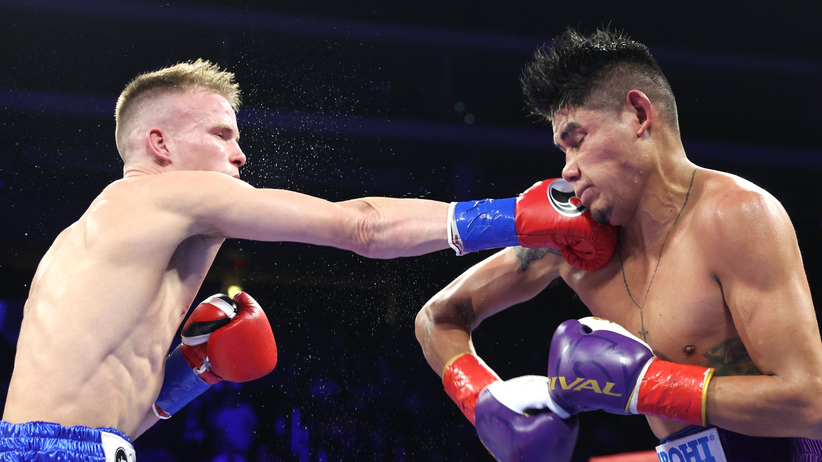 Liam Wilson (L) and Emanuel Navarrete (R) exchange punches during their vacant WBO junior lightweight championship fight at Desert Diamond Arena on February 03, 2033 in Glendale, Arizona. (Photo by Mikey Williams/Top Rank Inc via Getty Images)