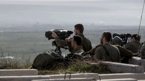 Israeli soldiers taking positions next to the Israeli-Syrian border following the Israel attack in Syria. (AAP)
