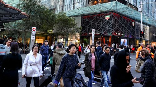 Shoppers walk through Sydney CBD after the Omicron wave lockdown was lifted.