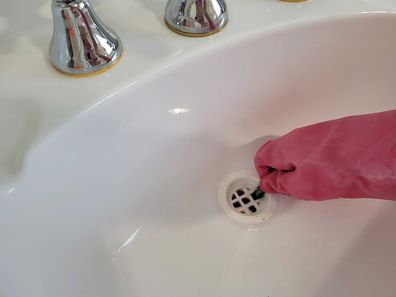 Bathroom basin sink hole cleaning task
