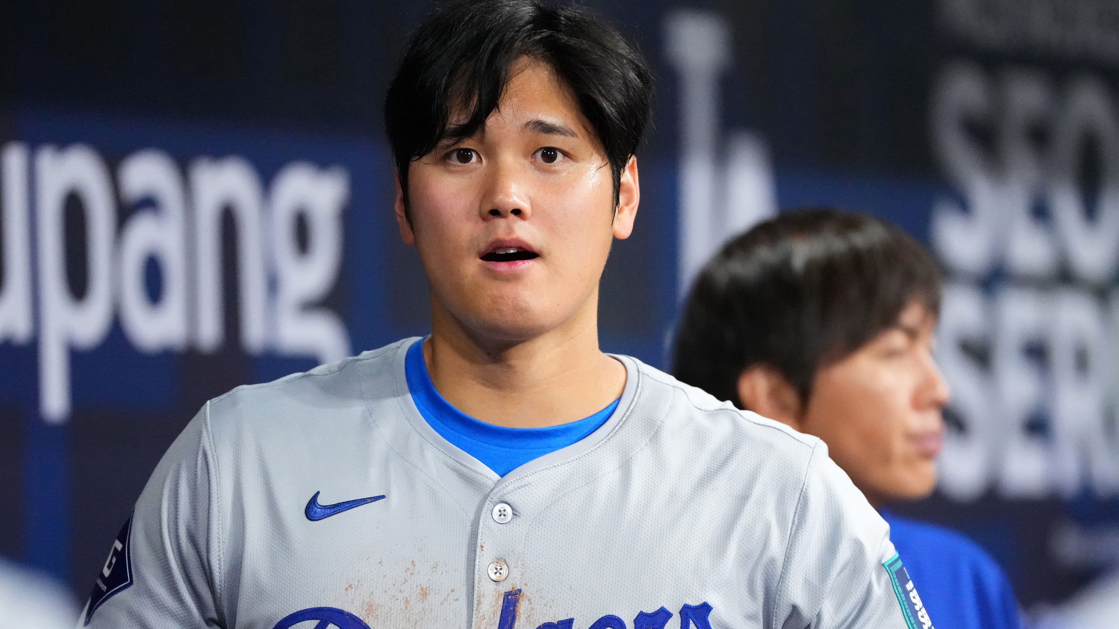 Shohei Ohtani #17 of the Los Angeles Dodgers is seen while his interpreter Ippei Mizuhara is seen in the dugout during the 2024 Seoul Series game between Los Angeles Dodgers and San Diego Padres at Gocheok Sky Dome on March 20, 2024 in Seoul, South Korea. (Photo by Masterpress/Getty Images)