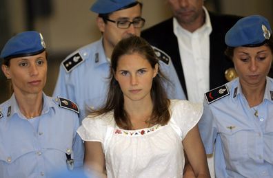 Amanda Knox being escorted by Italian penitentiary police officers from Perugia's court after a hearing, central Italy, Tuesday Sept. 16, 2008.