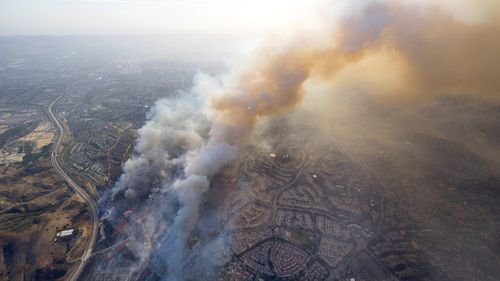 A wildfire moves closer to North Tustin homes along the 261 freeway in Tustin, Calif. (AP)