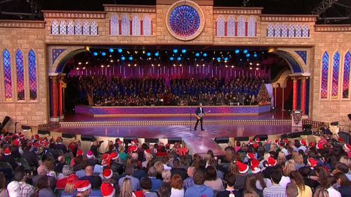 At least 10,000 are at the Sidney Myer Music bowl for Carols by Candlelight. (Channel 9)