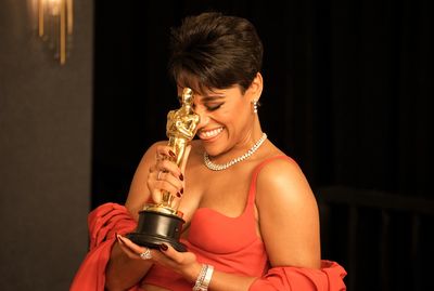 Ariana DeBose poses with her Oscar for playing Anita in the 2021 adaptation of West Side Story.