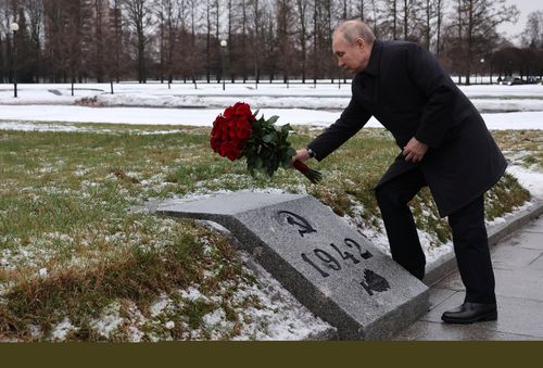 Russian President Vladimir Putin attends events marking the 80th anniversary of the break of the Nazi siege of Leningrad, (now St. Petersburg) during World War Two at the Piskaryovskoye Memorial Cemetery, where hundreds of thousands of siege victims are buried, in St. Petersburg, Russia, Wednesday, Jan. 18, 2023 