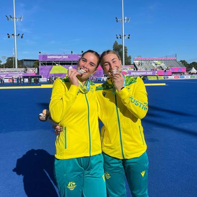 Grace Stewart and fellow Hockeyroo Mariah Williams pose with their Commonwealth Games silver medals.