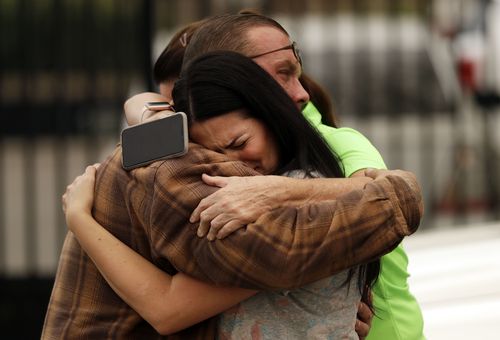 Friends of the Bledsoe family embrace outside of the sheriff's office after hearing news of their deaths. Picture: AAP