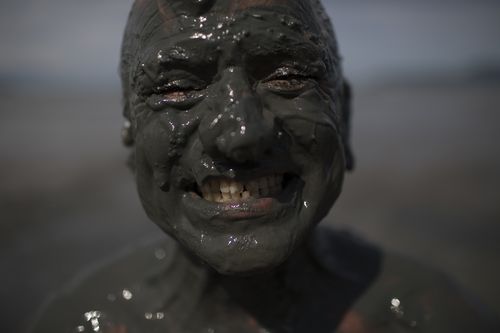 Hundreds of people took part in the muddy fun. (AP)