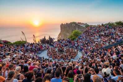 Bali, Indonesia - June 24, 2019: Traditional Kecak Fire Dance performance at Uluwatu Temple at sunset in Bali, Indonesia.
