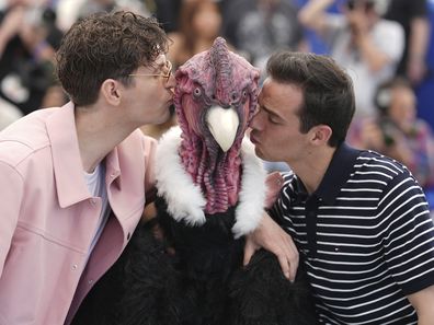 Raphael Quenard and Hugo David pose with a person dressed in bird costume at a photocall for the film Die, My Love at the 78th international film festival, Cannes, May 18, 2025.