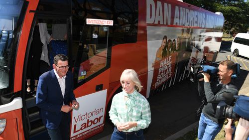 Daniel Andrews and wife Catherine hop off the Labor campaign bus.
