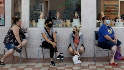 In this May 6, 2020, file photo customers wait for to get their nails done at the Nail Tech salon in the Yuba Sutter Mall in Yuba City, Calif.  (AP Photo/Rich Pedroncelli, File)