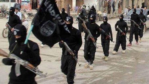 Islamic State fighters parade through the streets of Mosul. (AP)