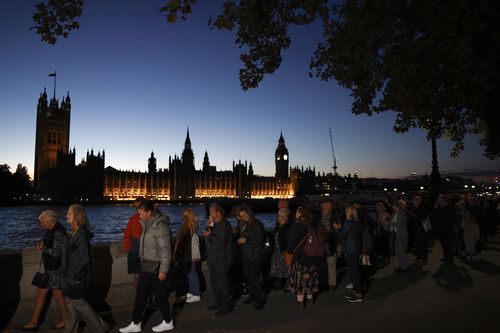 Members of the public stand in the queue in the evening for the Lying-in State of Queen Elizabeth II on September 16, 2022 in London, United Kingdom. Queen Elizabeth II is lying in state at Westminster Hall until the morning of her funeral to allow members of the public to pay their last respects. Elizabeth Alexandra Mary Windsor was born in Bruton Street, Mayfair, London on 21 April 1926. She married Prince Philip in 1947 and acceded to the throne of the Un