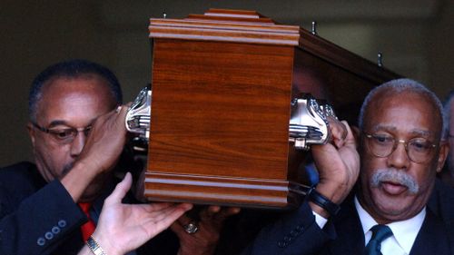 Smith (left) and Carlos carry the coffin of  Norman in Melbourne, in 2006.  (AAP)