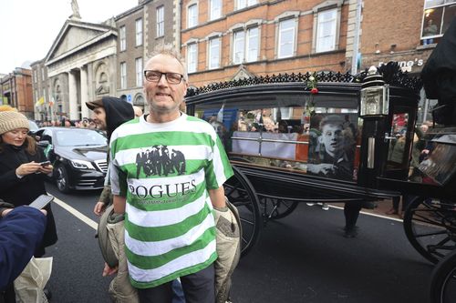 Tomas, no surname given, who travelled from Sweden to attend the funeral, stands on Westland Row as the funeral procession of Shane MacGowan makes its way through the streets of Dublin, ahead of his funeral in Co Tipperary, in Ireland, Friday, Dec. 8, 2023.  