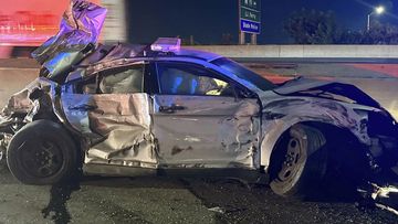 This image released by the Connecticut State Police, Tuesday, July 18, 2023, shows one of of two state police cruisers damaged when human waste, leaking from a tractor trailer, turned Interstate 95 in Bridgeport, Conn., into a virtual skating rink, causing multiple crashes, Monday night, July 17, 2023. State police charged the driver with reckless driving, reckless endangerment and failing to secure a load. 
