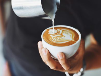 Stock image of a barista pouring a coffee.