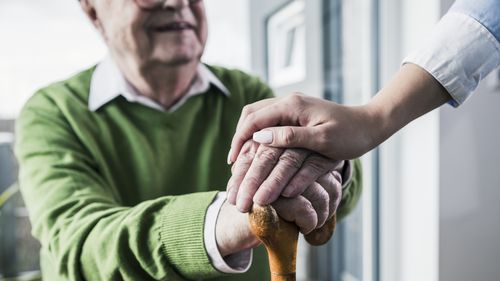 Elderly man with walking stick