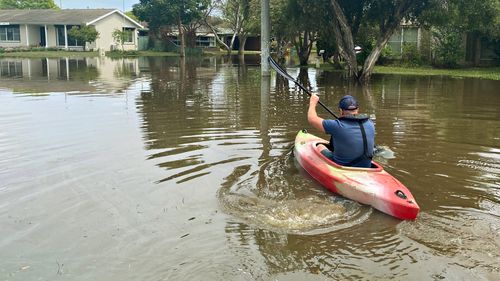 The Age photographer Jason South rows across flood water to get to a community stranded from the rest of Shepparton.