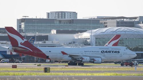 A Qantas aircraft on the tarmac at Sydney Airport, Friday, March 20, 2020.