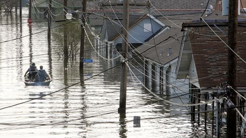 FILE - In this Tuesday, Aug. 30, 2005 file photo, Rescue personnel search from victims as they traverse the New Orleans 8th Ward in the flooded city of New Orleans. Water continues to rise after the onslaught of Hurricane Katrina. Hurricane Ida looks an awful lot like Hurricane Katrina, bearing down on the same part of Louisiana on the same calendar date. But hurricane experts say there are differences in the two storms 16 years apart that may prove key and may make Ida nastier in some ways but 