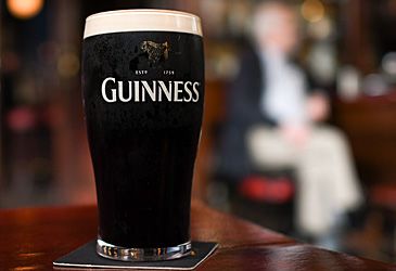 What is Guinness Extra Stout's alcohol content by volume in Australia?