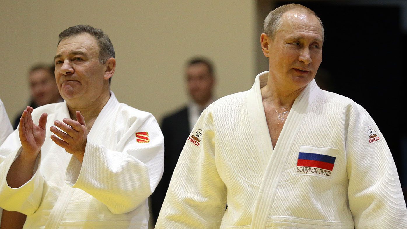 Russian President Vladimir Putin (R) and billionaire Arkady Rotenberg (L) attend judo training 