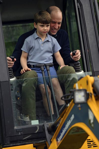 Prince William is helped by Prince Louis as he uses an excavator while taking part in the Big Help Out, during a visit to the 3rd Upton Scouts Hut in Slough, England, Monday, May 8, 2023