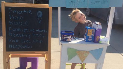Young boy spending his summer raising money for sick children with ice cream stand 