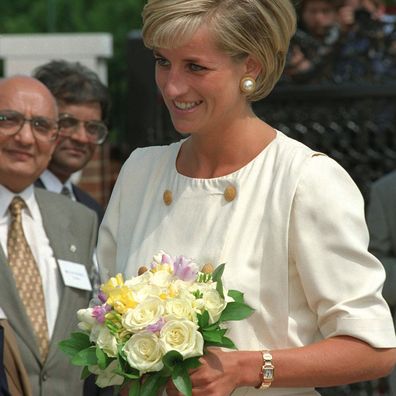 Princess Diana wearing her gold Cartier Tank Francaise watch in 1997.