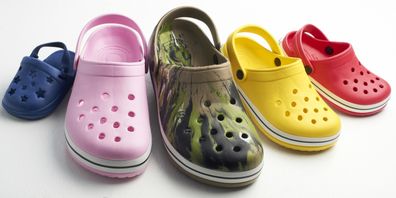 A group of casual clog shoes: Crocs in different colours