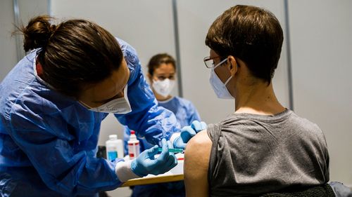 A medical student is vaccinated during a trial in Freiburg, Germany.