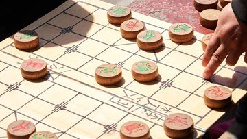 Xiangqi board with some pieces on it.