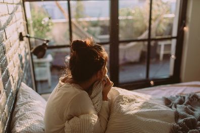 Portrait of a young woman waking up with a morning sunlight