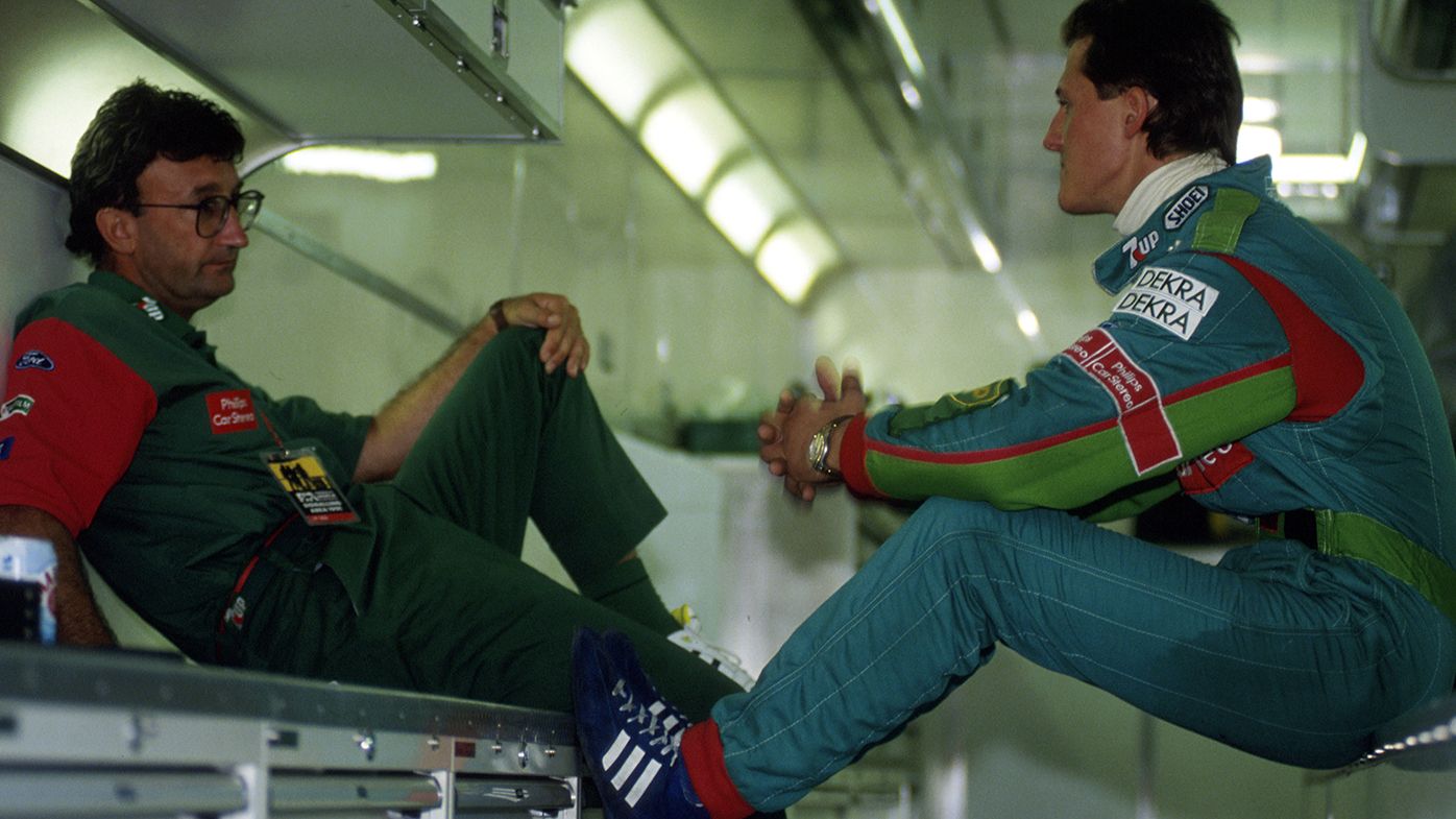 Team boss Eddie Jordan talks to Michael Schumacher at the 1991 Belgian Grand Prix.