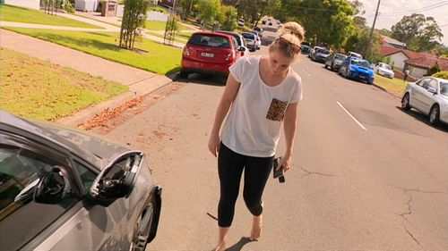 Cherilyn Dovey examines the damage to her car. 