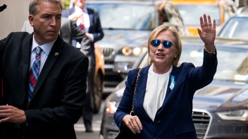 Hillary Clinton waved as she left her daughter's apartment. (AAP)