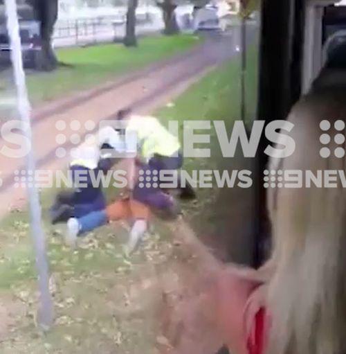 The man was pinned to the ground and detained after stumbling from the bus. (9NEWS)