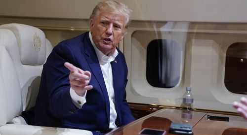 Former President Donald Trump speaks with reporters while in flight on his plane after a campaign rally at Waco Regional Airport, in Waco, Texas, Saturday, March 25, 2023, 